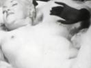 A blonde, chubby looking girl is on a bed of furs, showing her naked body off to the camera. She strokes her whole body and hides her pussy by lifting her legs just in time, looking very seductive.