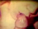 A guy is laying down on tha couch where a red headed girl is taking his clothes off. A little later she is on top of him with his dick buried deep into her asshole. Then she gives him an extensive blow job until he comes in her mouth.