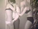 A gauy is standing in between two girls who are wearing bikinis. He begins to kiss one of them while the other unbuttons his shirt. A little later he is fucking one of the girls. Then the other one rolls him on his back and lowers herself over his dick.