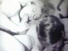 Two couples are sitting around a table playing strippoker. A little later all four of them are on the bed and the girls are sucking the guys dicks. Then both girls are put on a table so the guys can fuck them.