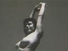In this black and white movie we see a girl in white panties walking onto a beach, her tits covered by a string of flowers. She pulls the flowers away, showing a pair of firm boobs. She then takes off her panties and poses in front of the camera.