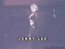 Vintage porn model Jenny Lee stars in this black and white movie. She is standing on a stage dressed in a long, black gown and a black bra. Doing a slow striptease she reveals her firm breasts which have tassels on the nipples that she waves about. Dancing around she is on the verge of lowering her panties...