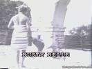 In this vintage silent movie a blond girl with very large boobs is sweeping the street. She is wearing a striped dress that she takes off to show her naked body, especially her enormous tits.