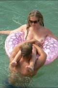 Nudists caught splashing in the sea and taking a tan