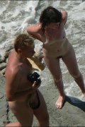A nude couple gets caught on tape having beach fun