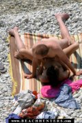 Happy nudist couple have slow sex near the water