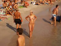 Shy teen pops her top off for all the beach goers
